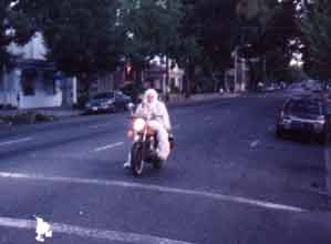 mugatu riding motorcycle on way to show